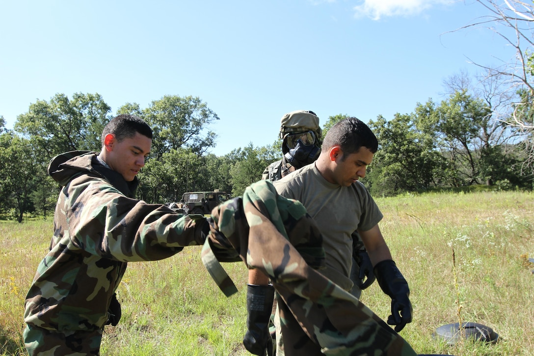 Army Reserve Soldiers from the 340th Chemical Company out of Houston, Texas, assist each other in the removal of Mission Oriented Protective Posture (MOPP) gear during a training event as part of the Combat Support Training Exercise (CSTX) here in Fort McCoy, Wis. on Aug. 14. CSTX immerses Army Reserve soldiers and other service members in real-world training scenarios to enhance unit readiness in the planning, preparation, and execution of combat service support operations. (U.S. Army photo by Spc. Christopher A. Hernandez, 345th Public Affairs Detachment)