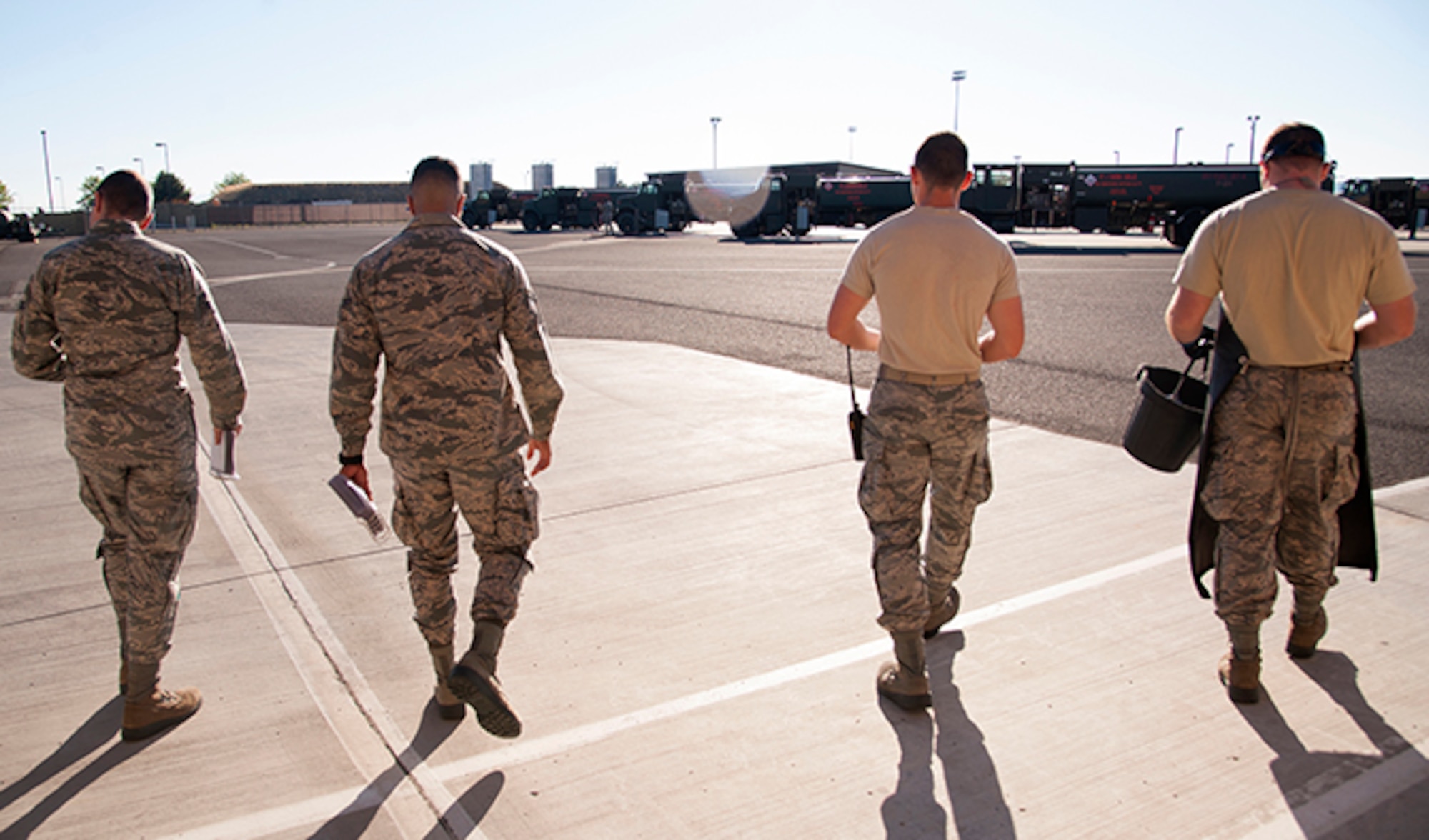(From left to right) 92nd Logistics Readiness Squadron refueling equipment operators: Senior Airman Devin Carpenter, Airman 1st Class Robert Santana, Airman 1st Class Alexander Munson and Airman Victor Ortiz walk out to the fuel equipment staging area July 25, 2016, at Fairchild Air Force Base, Wash. At the start of every shift, fuels equipment operators go through an extensive checklist to ensure operational safety. (U.S. Air Force photo/ Airman 1st Class Ryan Lackey)