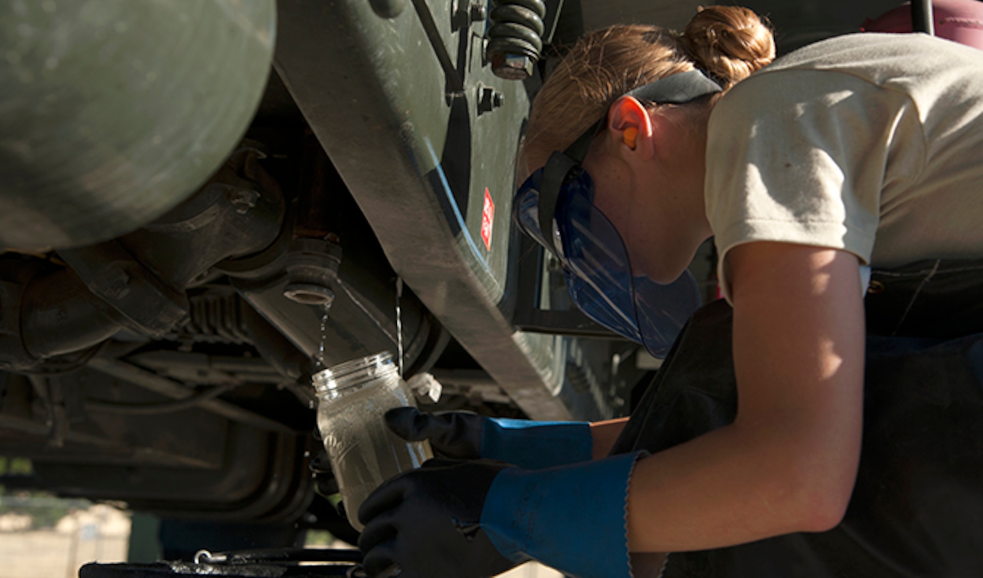 Airman Lorinda Hochstetler, 92nd Logistics Readiness Squadron refueling equipment operator, checks the quality of the fuel inside the R-11 fuel tanker trucks at the fuel equipment staging area July 25, 2016, at Fairchild Air Force Base, Wash. Vital to ensure that no contaminants make it into aircraft, fuels airmen check fuel purity regularly. (U.S. Air Force photo/ Airman 1st Class Ryan Lackey)