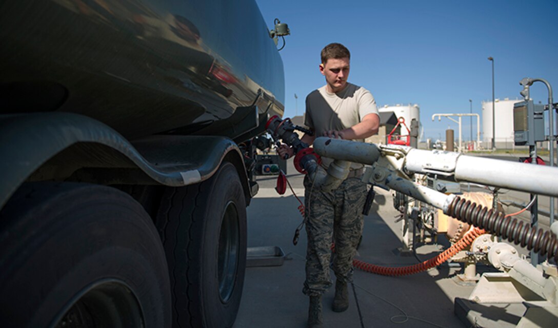 Airman 1st Class Michael Peek, 92nd Logistics Readiness Squadron refueling equipment operator, wrangles a pipe hookup from a pumping station to a R-11 fuel tanker truck July 26, 2016, at Fairchild Air Force Base, Wash. Vital to ensure that no contaminants make it into aircraft, fuels airmen check fuel purity regularly. (U.S. Air Force photo/ Airman 1st Class Sean Campbell)