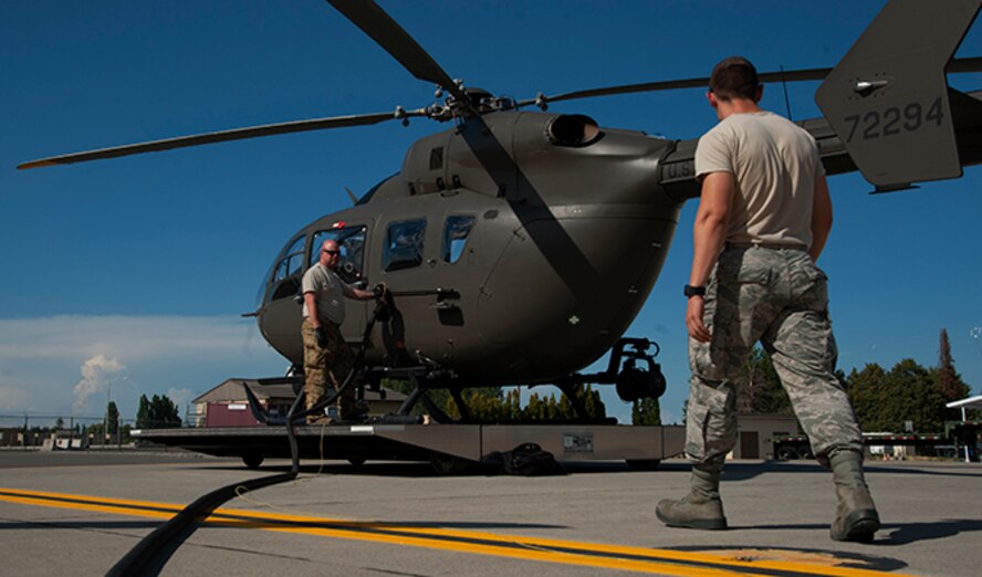 Senior Airman Devin Carpenter, 92nd Logistics Readiness Squadron refueling equipment operator, works with Staff Sgt. Scott Johnson, 140th Aviation Brigade, Washington Army National Guard, aircraft mechanic, to refuel a UH-72 Lakota helicopter July 25, 2016, at Fairchild Air Force Base, Wash. Not limited to tanker aircraft, the fuels flight responds to all requests for fuel. (U.S. Air Force photo/ Airman 1st Class Ryan Lackey)