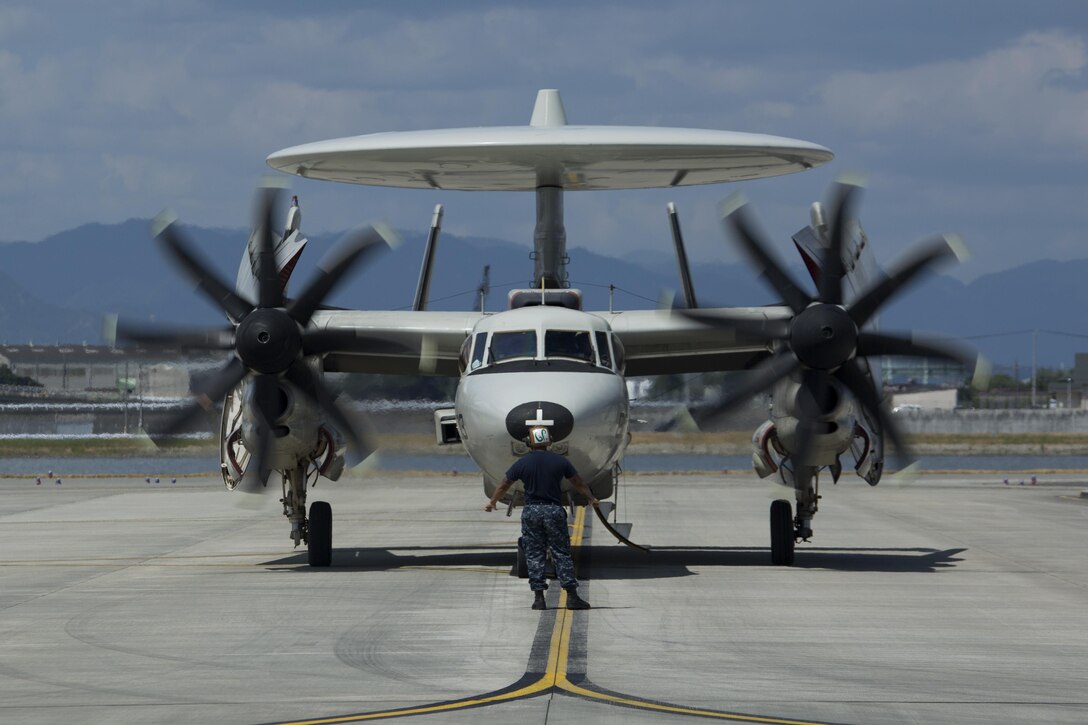 A U.S. Navy E-2C Hawkeye assigned to Carrier Airborne Early Warning Squadron (VAW) 115, with Carrier Air Wing 5, taxis into hot refueling pits at Marine Corps Air Station Iwakuni, Japan, Aug. 17, 2016. While passing through the air station for aircraft-based training, maintainers inspected and refueled the Hawkeyes before their retrograde back to Naval Air Facility Atusgi. The all-weather, carrier-based, tactical battle management airborne early warning command and control aircraft became operational in 1973 and underwent several upgrades. Variants of this aircraft are also flown by the Egyptian Air Force, Japanese Air Self-Defense Force, Republic of Singapore Air Force, Taiwan Air Force, and the French Navy. (U.S. Marine Corps photo by Lance Cpl. Donato Maffin)