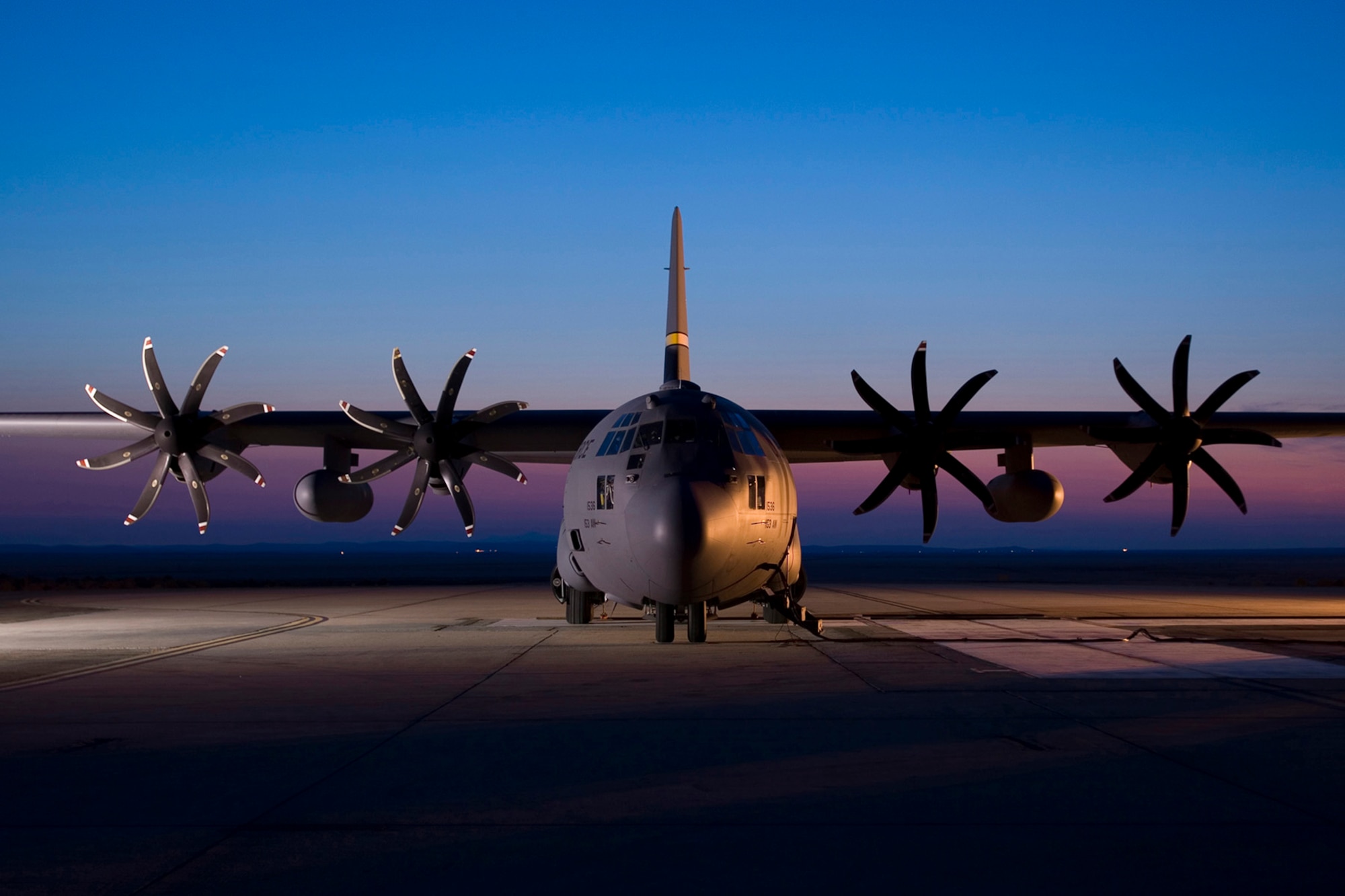 A C-130H Hercules aircraft assigned to the 153rd Airlift Wing, Wyoming Air National Guard is seen parked on the ramp at Edwards AFB in California. The C-130 is modified with an Electronic Propeller Control System and eight-bladed propeller system. (Courtesy photo)