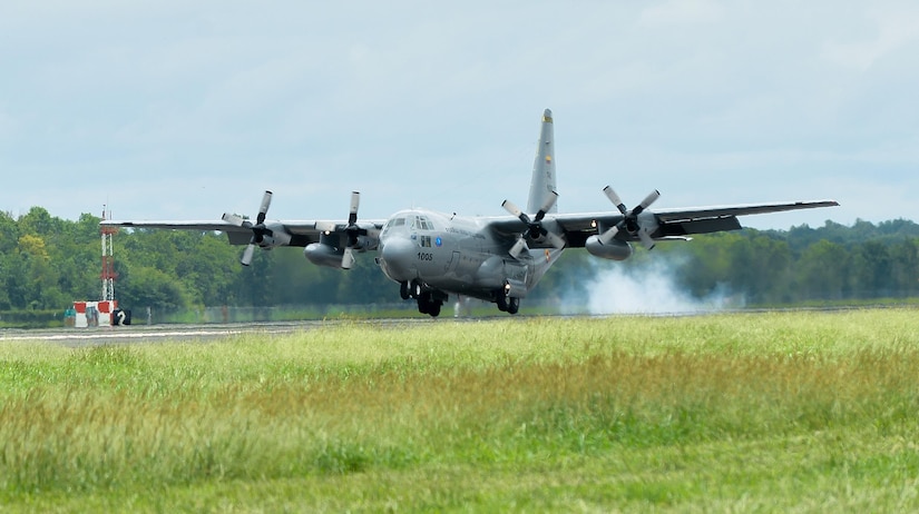 An aircraft lands on a runway.