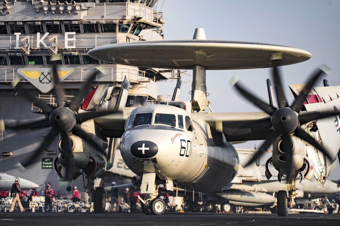 An E-2C Hawkeye taxis across the flight deck of the aircraft carrier USS Dwight D. Eisenhower in the Arabian Gulf, Aug. 8, 2016.  The Hawkeye is assigned to Airborne Early Warning Squadron 123. The aircraft carrier is supporting Operation Inherent Resolve, maritime security operations and theater security cooperation efforts in the U.S. 5th Fleet area of operations. Navy photo by Petty Officer 3rd Class J. Alexander Delgado 
