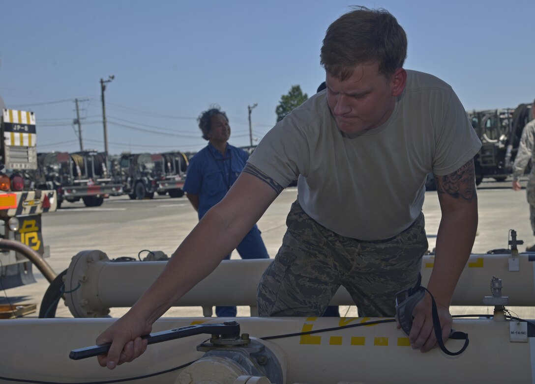 Airman 1st Class David Nemetz, 374th Logistics Readiness Squadron fuels laboratory technician, opens a fuel line at Yokota Air Base, Japan, Aug. 17, 2016. Once the process is complete, the fuel is provided to Yokota's aircraft in order for the pilots to complete their missions of swiftly providing airpower throughout the Indo-Asia Pacific Region to defend the U.S. nation, support America's partners, and promote a free and stable world. (U.S. Air Force photo by Senior Airman David Owsianka/Released)