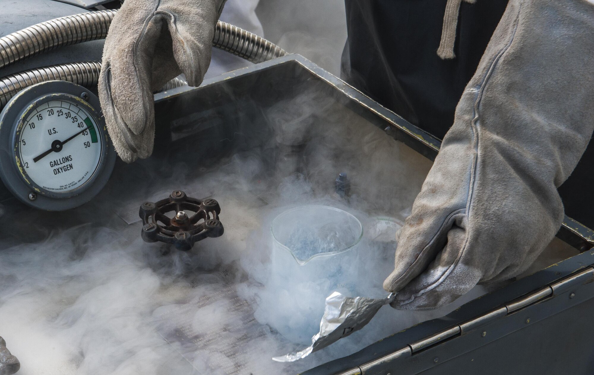 Senior Airman Brandon Avery, a cryogenics technician with the 18th Logistics Readiness Squadron, seals a sample of liquid oxygen Aug. 17, 2016, at Kadena Air Base, Japan. Liquid oxygen is used primarily for aircraft so pilots can breathe, as well as for patients on oxygen during things like emergency evacuation flights. (U.S. Air Force Photo by Airman 1st Class Nick Emerick)