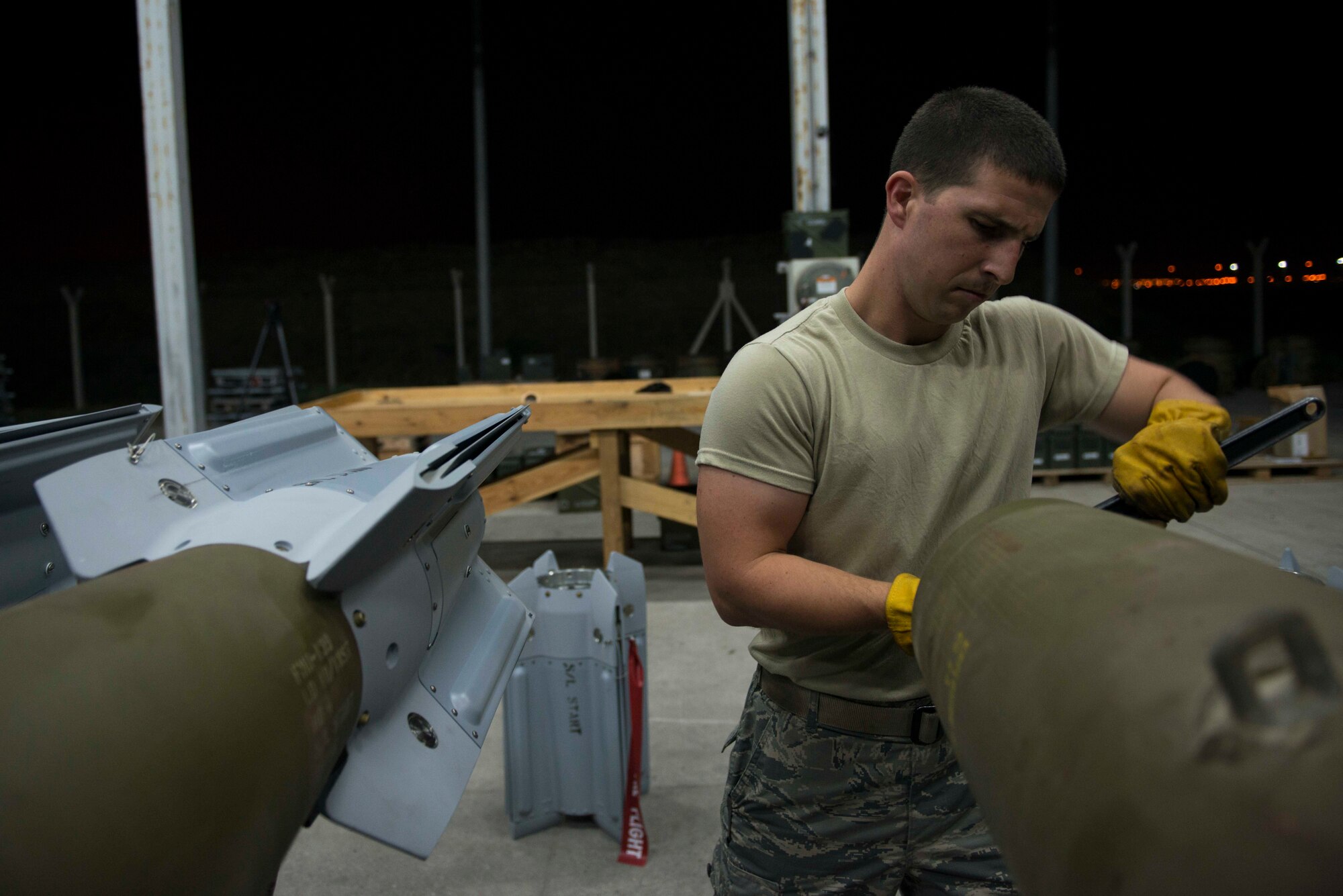 U.S. Air Force Staff Sgt. Curtis Downer, 447th Expeditionary Aircraft Maintenance Squadron munitions systems specialist, cleans thread wells on a GBU-12 Paveway II laser-guided bomb Aug. 8, 2016, at Incirlik Air Base, Turkey. Thread wells are cleaned prior to installing the fin to ensure a safe and secure attachment. (U.S. Air Force photo by Senior Airman John Nieves Camacho)