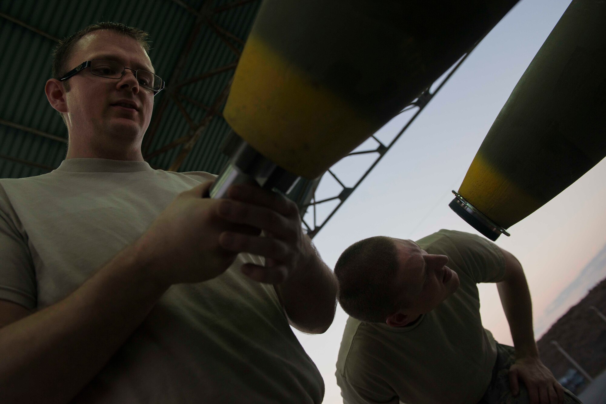 U.S. Air Force Tech. Sgt. Andrew Danielson (left) and Staff Sgt. Shadrach Mchargue, 447th Expeditionary Aircraft Maintenance Squadron munitions systems specialists, prepare GBU-12 Paveway II laser-guided bombs for transport Aug. 8, 2016, at Incirlik Air Base, Turkey. Upon completion, munitions are transported to either aircraft or storage. (U.S. Air Force photo by Senior Airman John Nieves Camacho)