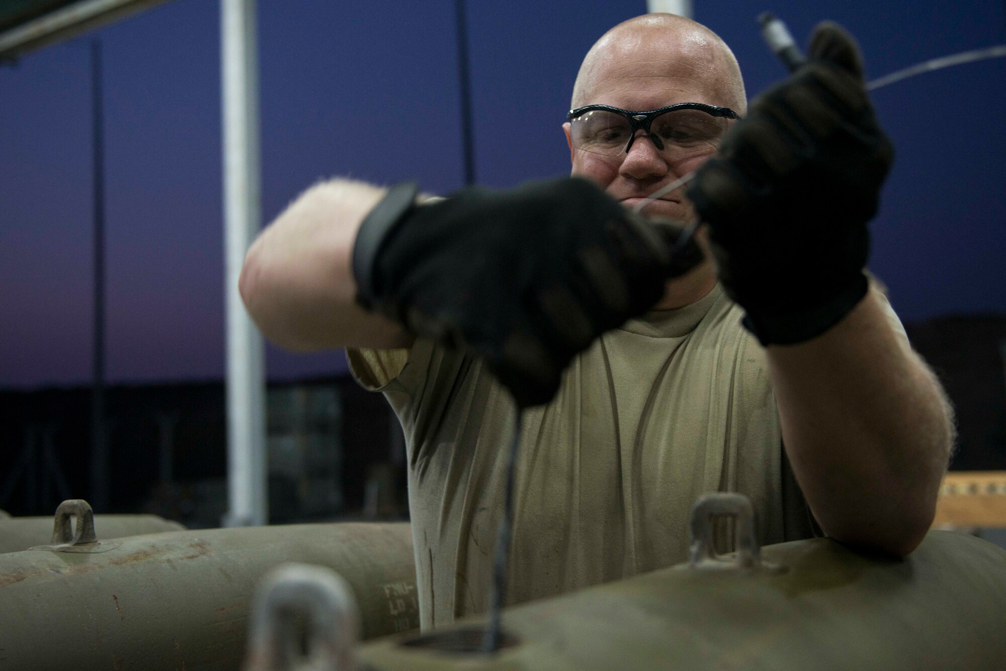 U.S. Air Force Staff Sgt. Adam Daley, 447th Expeditionary Aircraft Maintenance Squadron (EAMXS) munitions systems specialist, routes fuse cables on a GBU-12 Paveway II laser-guided bomb Aug. 8, 2016, at Incirlik Air Base, Turkey. The Airmen assembled munitions for the A-10 Thunderbolt II. (U.S. Air Force photo by Senior Airman John Nieves Camacho)