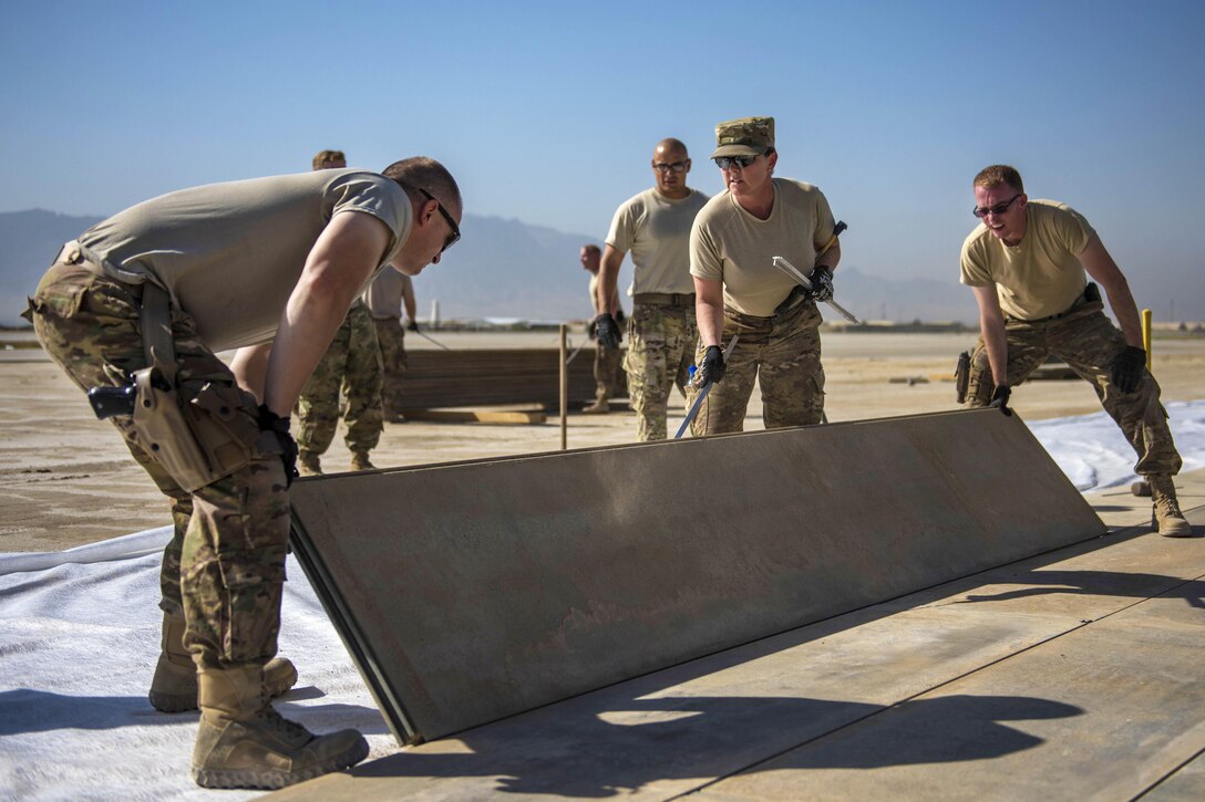 Airmen expand a ramp on the flightline at Bagram Airfield in Afghanistan, Aug. 11, 2016. The airmen are assigned to the 455th Expeditionary Civil Engineer Squadron. The project will allow aircraft to taxi in and out faster, decreasing response times for pilots. Air Force photo by Senior Airman Justyn M. Freeman 