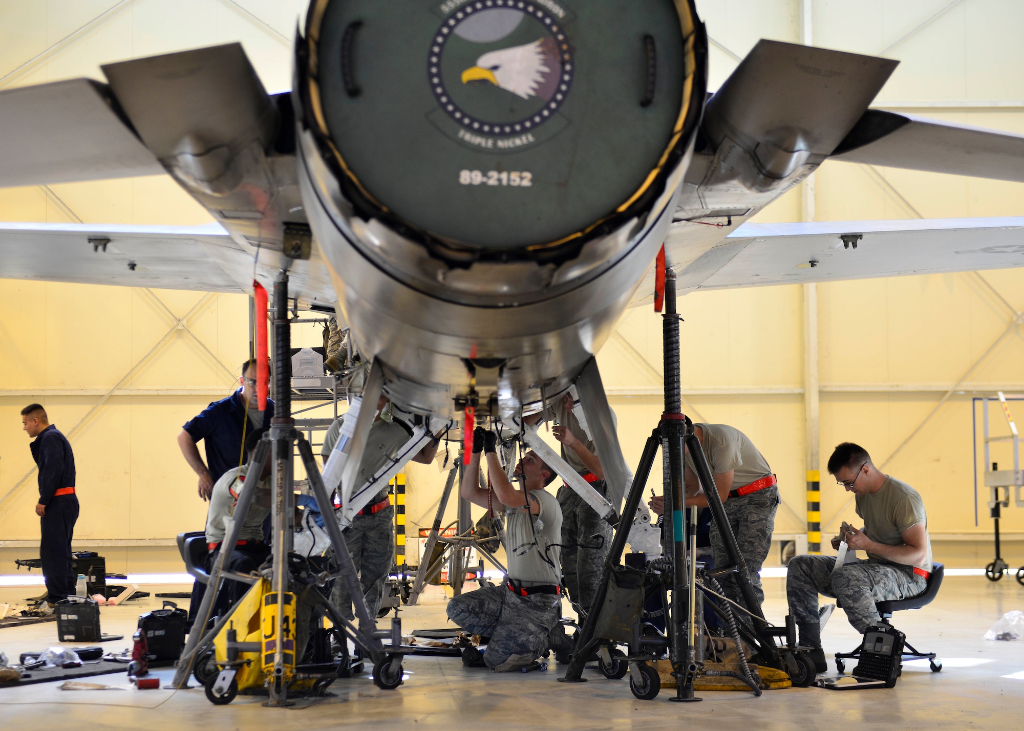 Crew chiefs from the 31st Maintenance Squadron phase maintenance section replace an F-16 Fighting Falcon’s landing gear, Aug. 15-17, 2016, at Aviano Air Base, Italy. Phase crew chiefs perform scheduled aircraft phase inspections and assist maintenance shops with repairing specialized parts such as landing gear struts. (U.S. Air Force photo by Airman 1st Class Cary Smith/Released)