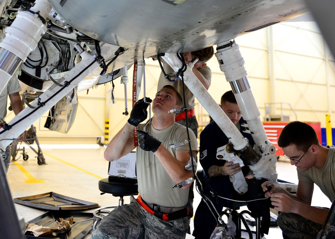 Crew chiefs from the 31st Maintenance Squadron phase maintenance section replace an F-16 Fighting Falcon’s landing gear, Aug. 15 – 17, 2016, at Aviano Air Base, Italy. Phase inspections occur every 400 flying hours and landing gears are replaced every six years. (U.S. Air Force photo by Airman 1st Class Cary Smith/Released)