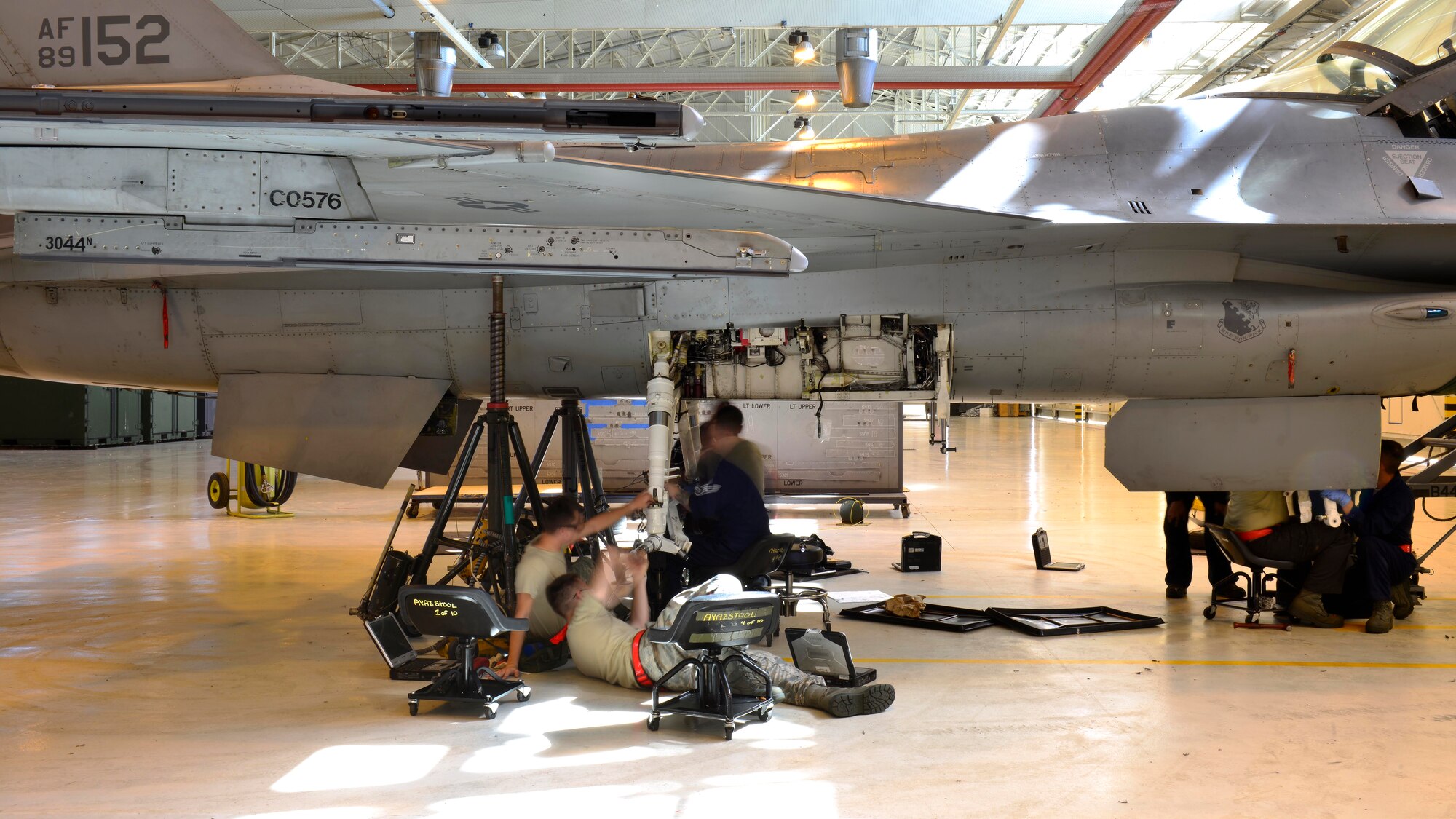 Crew chiefs from the 31st Maintenance Squadron phase maintenance section replace an F-16 Fighting Falcon’s landing gear, Aug. 15-17, 2016, at Aviano Air Base, Italy. In addition to performing phase inspections, phase maintenance crew chiefs sometimes assist other maintenance sections with aircraft repairs. (U.S. Air Force photo by Airman 1st Class Cary Smith/Released)