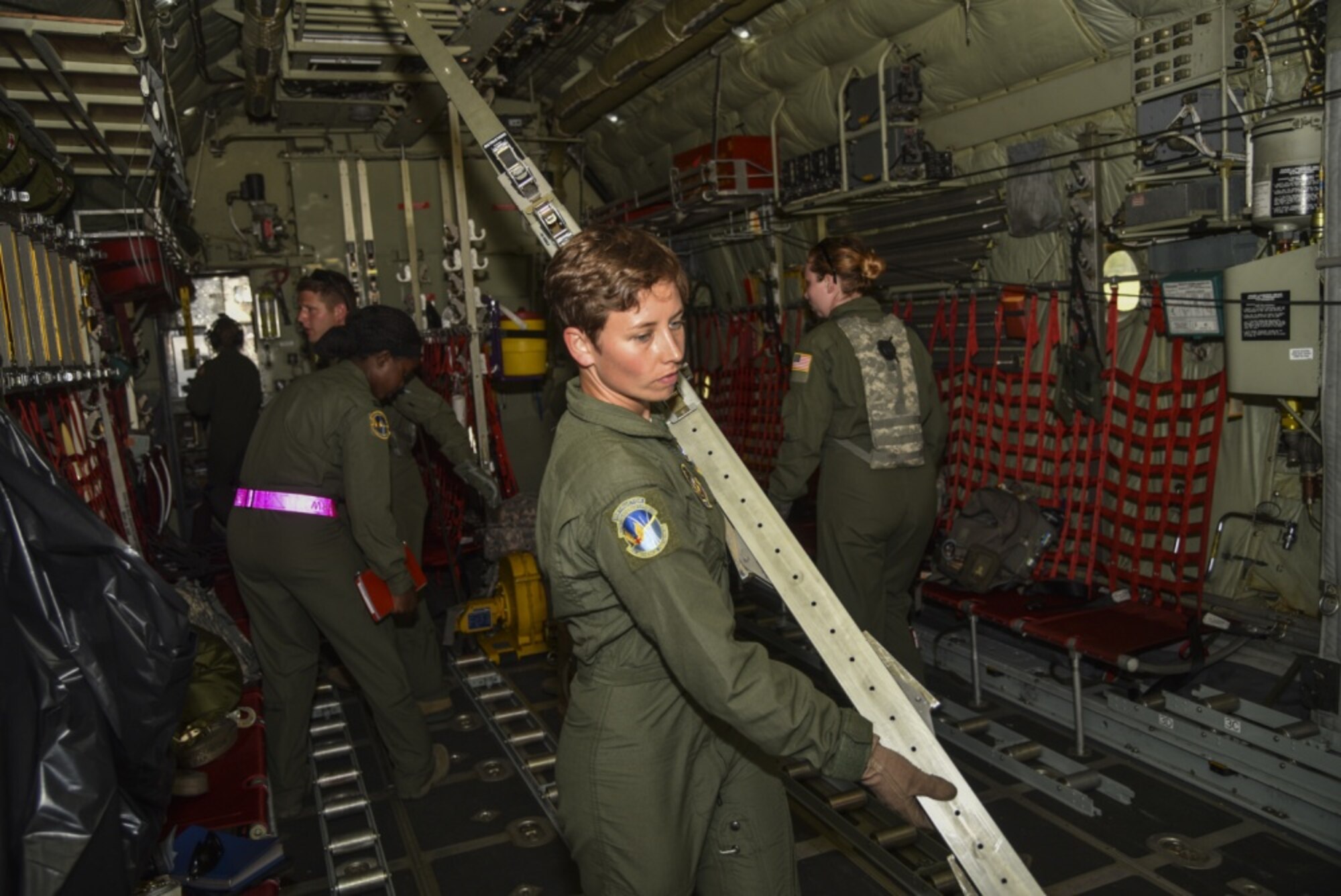 Staff Sgt. Jackie Kvilhaug, 45th Aeromedical Evacuation Squadron, aeromedical evacuation technician, along with other AE teammates from Air Force Reserve Command, convert a C-130 Hercules into a mobile hospital preparing for Patriot Warrior exercise at Fort McCoy, Wis., August 15, 2016. Patriot Warrior is a joint exercise designed to demonstrate contingency deployment training ranging from bare base buildup to full operational capabilities. More than 11,000 members from the U.S. service branches and their Reserve components, including Air Force, Army, Navy, and Marines are participating alongside British, Canadian, and Saudi Arabian forces. This exercise evaluates the ability of Air Force Reserve units to deploy mobility airlift and agile combat support capabilities in support of joint theater operations. (U.S. Air Force photo by Staff Sgt. Adam C. Borgman) 