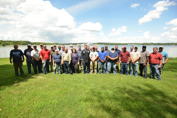 Lt. Col. Stephen Murphy, U.S. Army Corps of Engineers Nashville District commander, poses with past and present members of the Nashville District Repair Fleet during a ceremony recognizing their service at Old Hickory Dam in Old Hickory, Tenn., Aug. 15, 2016. He also presented them with certificates of achievement in recognition of their service to the fleet as it reorganizes into a regional light repair fleet.