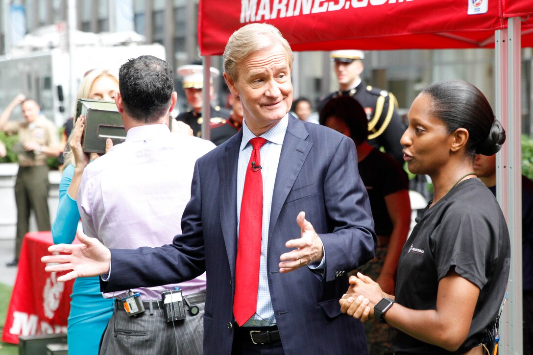 U.S. Marine Corps 1st Lt. Carmella Shivers, an officer selection officer with Recruiting Station New York, speaks to the hosts of Fox & Friends about women joining the military and physical fitness standards in the Marine Corps outside of the Fox News building in New York City, Aug. 17, 2016. The Marines visited Fox & Friends, a popular morning show, to demonstrate their commitment to female Marines and to the integration of women into combat military occupational specialties. (U.S. Marine Corps photo by Cpl. Brandon Thomas)