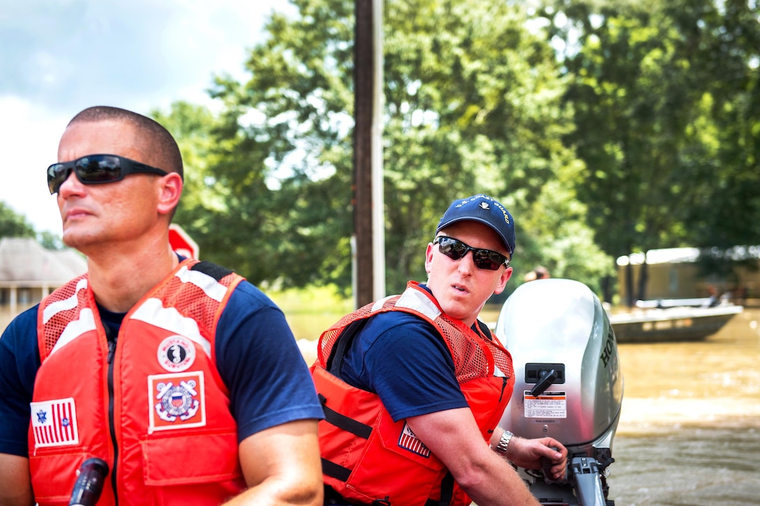 Coast Guard Petty Officers 3rd Class Josh Bryant and Mike Ramos search for stranded residents in high water near Baton Rouge, La., Aug. 16, 2016. Coast Guard photo by Petty Officer 2nd Class LaNola Stone