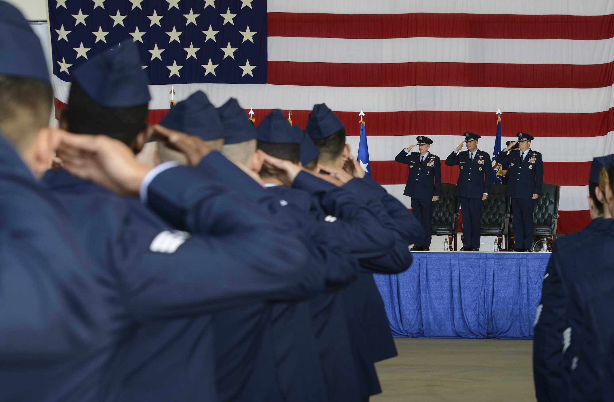 The 86th Airlift Wing Airmen salute during the playing of the U.S. and German national anthems during a change of command ceremony Aug. 17, 2016, Ramstein Air Base, Germany. Brig. Gen. Jon T. Thomas relinquished command of the 86th AW to Brig. Gen. Richard G. Moore Jr. (U.S. Air Force photo/ Airman 1st Class Joshua Magbanua)
