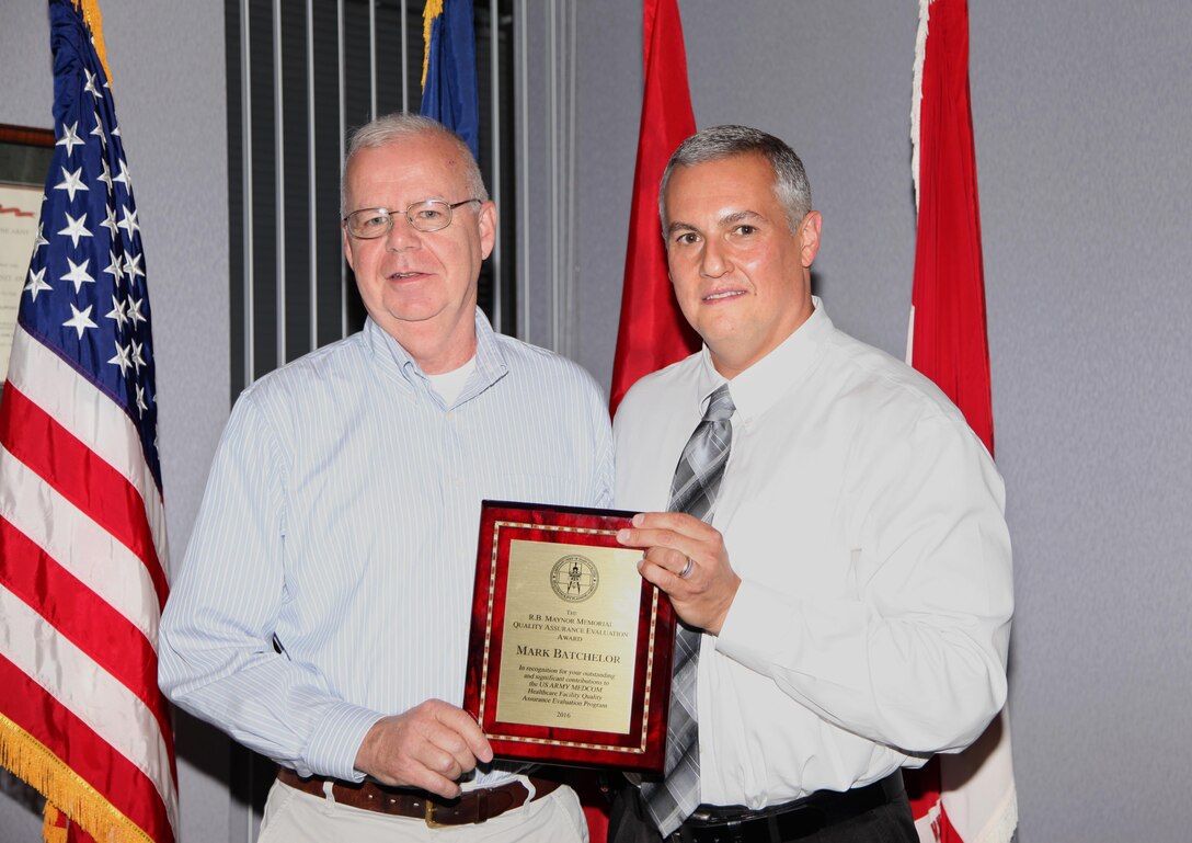 Brian Prediger, right, director of engineering, U.S. Army Medical Command, Health Facilitiy Planning Agency/G9, Falls Church, Virginia, presents Mark Batchelor, program manager, Medical Projects Support Services Program, U.S. Army Engineering and Support Center, Huntsville, Aug. 16, 2016.  It is the first time a U.S. Army Corps of Engineers employee has received the award.