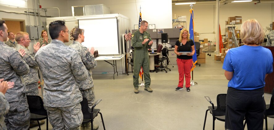 Team Barksdale members applaud Kimberly Farmer, 2nd Medical Support Squadron laboratory technician, after she was awarded the Command Civilian Award for Valor at Barksdale Air Force Base, La., Aug. 12, 2016. Farmer used CPR to save a man’s life while shopping at a convenience store in the local area. (U.S. Air Force photo/Senior Airman Curt Beach)