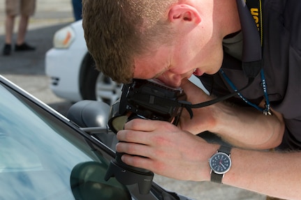 An Army Reserve military police and member of a training drug suppression team captures evidence photos of a vehicle identification number during a drug raid, as part of Guardian Shied, Aug 4, in Charleston, S.C.Agents from Criminal Investigation Commands across the United States, belonging to the 200th Military Police Command, gathered in Charleston, S.C., July 24 to Aug. 5, for Guardian Shield, 2016. Guardian Shield is a two-week training that certifies agents in various courses such as crime and intelligence analysis, drug suppression and domestic violence intervention. (U.S. Army photo by Sgt. Audrey Hayes)