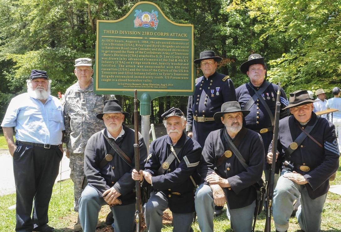 Army Reserve Lt. Col. L. Perry Bennett, division historian for the 4th Infantry Division, Fort Carson, Colorado and previous command historian for the 335th Signal Command (Theater), joins members of the Sons of Union Veterans of the Civil War and Sons of Confederate Veterans of the Civil War next to the new historical marker recognizing the sacrifice of those who fought in the Battle of Utoy Creek Aug. 4-7, 1864 during the Atlanta Campaign of the American Civil War at the Cascade Nature Preserve, East Point, Ga. Aug. 6. (U.S. Army photo by Sgt. Stephanie A. Hargett) (Released)