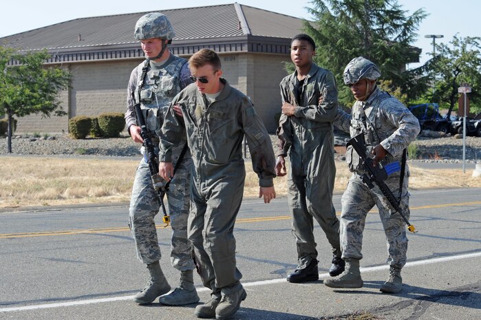 9th Security Forces members extract wounded Airmen from a building during an active shooter exercise Aug. 17, 2016, at Beale Air Force Base, California. The exercise evaluated Beale first responders actions if an occurrence, such as an active shooter, were to happen on the installation. (U.S. Air Force photo by Senior Airman Ramon A. Adelan) 