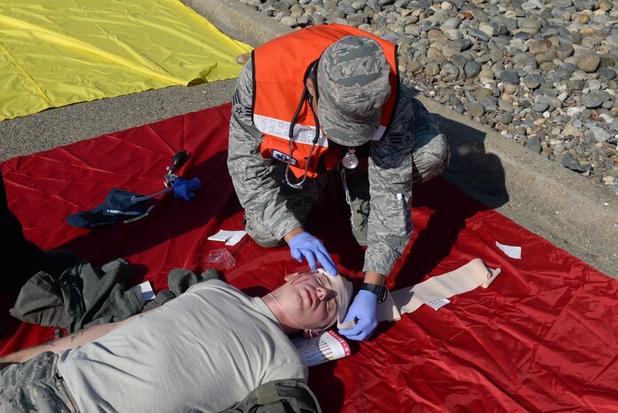 A first responder wraps a head wound of an Airman during an active shooter exercise Aug. 17, 2016, at Beale Air Force Base, California. The exercise evaluated Beale first responders actions if an occurrence, such as an active shooter, were to happen on the installation. (U.S. Air Force photo by Senior Airman Ramon A. Adelan) 