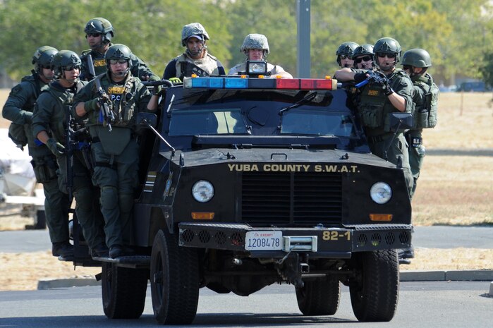 Yuba County Sheriff's Department SWAT and Beale first responders drive on scene to an active shooter exercise Aug. 17, 2016, at Beale Air Force Base, California. Beale personnel and Yuba County SWAT worked cohesively to extract individuals on lockdown and eliminate the simulated threat. (U.S. Air Force photo by Senior Airman Ramon A. Adelan) 