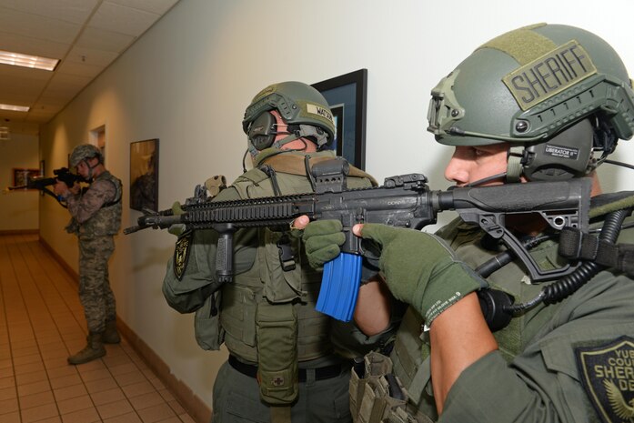 Yuba County Sheriff's Department SWAT members and a 9th Security Forces member stand guard during an active shooter exercise Aug. 17, 2016, at Beale Air Force Base, California. Beale personnel and Yuba County SWAT worked cohesively to extract individuals on lockdown and eliminate the simulated threat. (U.S. Air Force photo by Senior Airman Ramon A. Adelan) 