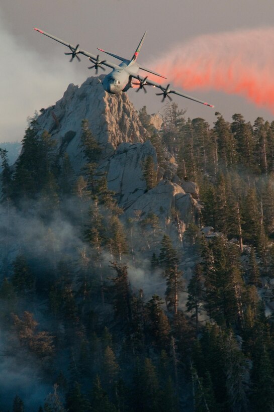 A California Air National Guard Modular Airborne Fire Fighting System-equipped C-130 Hercules aircraft drops fire retardant over Palm Springs Aerial Tramway to fight California wildfires, July 19, 2013. California Air National Guard photo by Staff Sgt. Nick Carzis