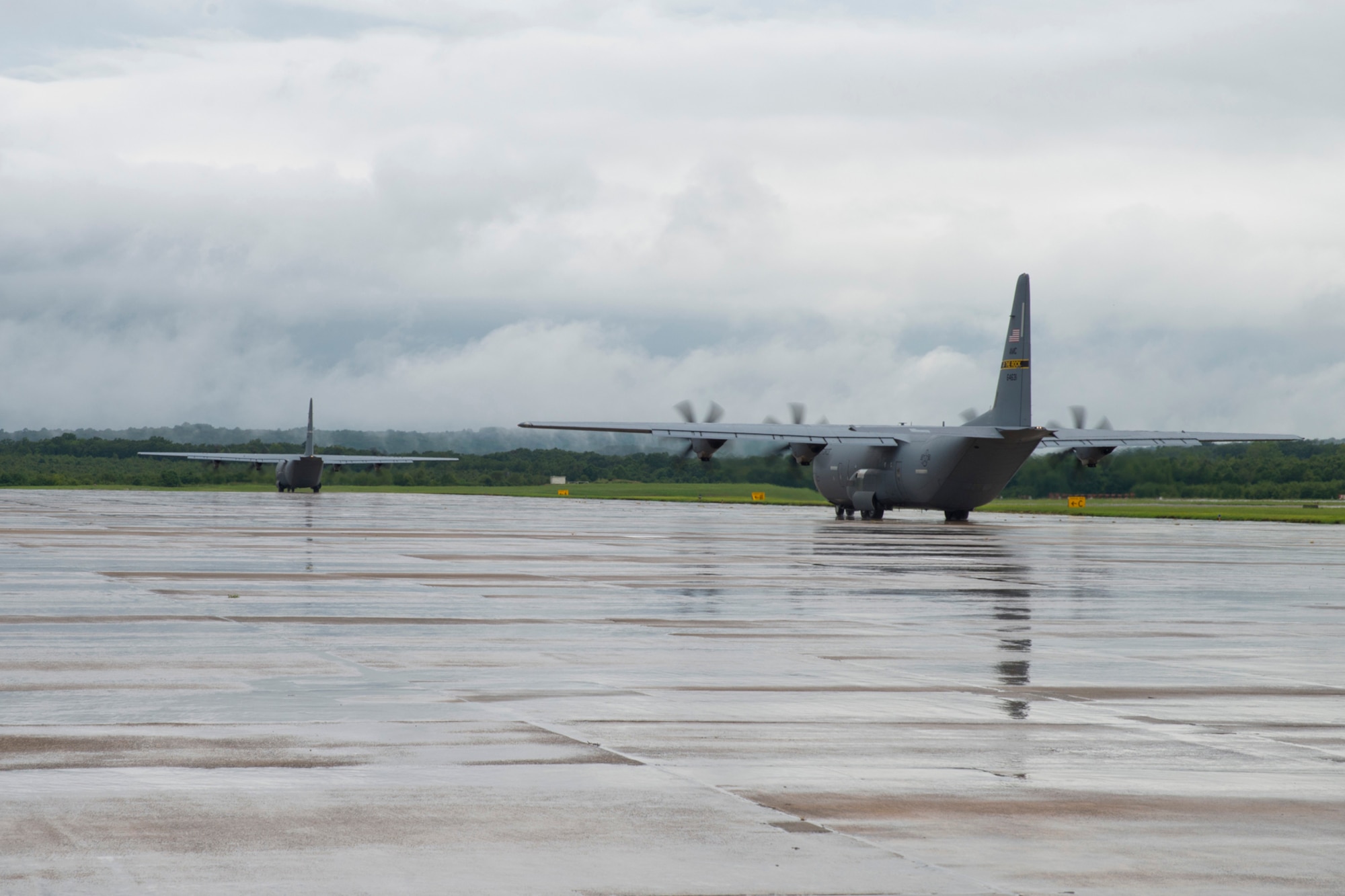 Two C-130J Super Hercules aircraft taxi to the runway at Little Rock Air Force base, Ark., Aug. 13, 2016. The two aircraft were part of a mission that passed a milestone for the 913th Airlift Group by being the first C-130J two-ship mission on a Unit Assembly Training weekend. (U.S. Air Force photo by Master Sgt. Jeff Walston) 