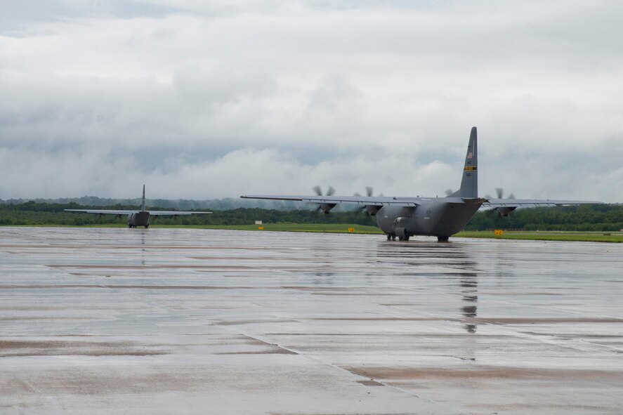 Two C-130J Super Hercules aircraft taxi to the runway at Little Rock Air Force base, Ark., Aug. 13, 2016. The two aircraft were part of a mission that passed a milestone for the 913th Airlift Group by being the first C-130J two-ship mission on a Unit Assembly Training weekend. (U.S. Air Force photo by Master Sgt. Jeff Walston) 