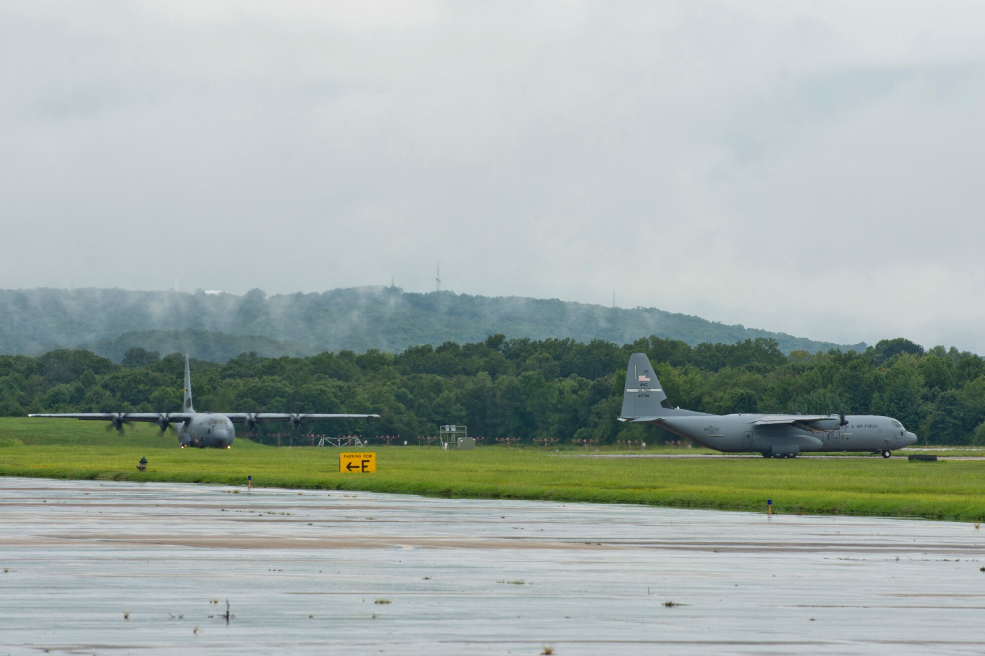 Two C-130J Super Hercules aircraft sit at the end of the runway waiting for permission to take off at Little Rock Air Force Base, Ark., Aug. 13, 2016. The two aircraft were part of a mission that passed a milestone for the 913th Airlift Group by flying the first C-130J two-ship mission on a Unit Assembly Training weekend. (U.S. Air Force photo by Master Sgt. Jeff Walston) 