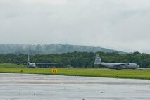 Two C-130J Super Hercules aircraft sit at the end of the runway waiting for permission to take off at Little Rock Air Force Base, Ark., Aug. 13, 2016. The two aircraft were part of a mission that passed a milestone for the 913th Airlift Group by flying the first C-130J two-ship mission on a Unit Assembly Training weekend. (U.S. Air Force photo by Master Sgt. Jeff Walston) 