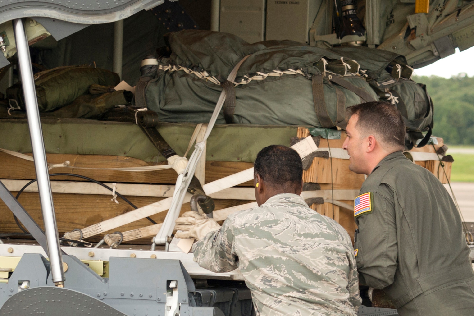 U.S. Air Force Reserve Master Sgt. Jimmy Massley (left) air transportation, 96th Aerial Port Squadron and Master Sgt. John R. Metcalf Jr., a 327th Airlift Squadron loadmaster, push a pallet onto a C-130J on the ramp at Little Rock Air Force Base, Ark., Aug. 13, 2016. The two Airmen helped in passing a milestone for the 913th Airlift Group by flying the first C-130J two-ship mission during a Unit Assembly Training weekend. (U.S. Air Force photo by Master Sgt. Jeff Walston) 