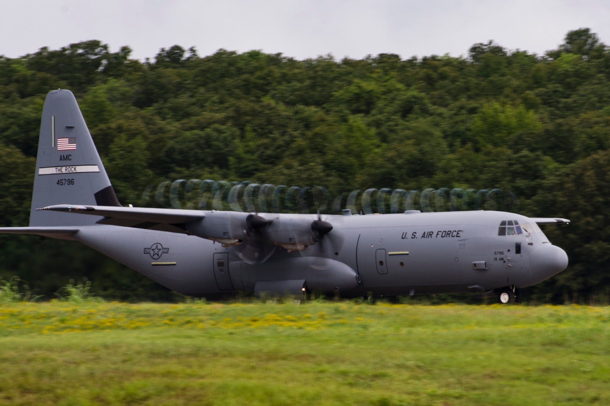 The presence of water on the runway creates a dynamic effect as a C-130J takes off from the runway at Little Rock Air Force Base, Ark., Aug. 13, 2016. The aircraft and aircrew were part of the first two-ship mission during a Unit Assembly Training weekend, since the 913th Airlift Group transitioned from the “H” to the “J” model. (U.S. Air Force photo by Master Sgt. Jeff Walston)