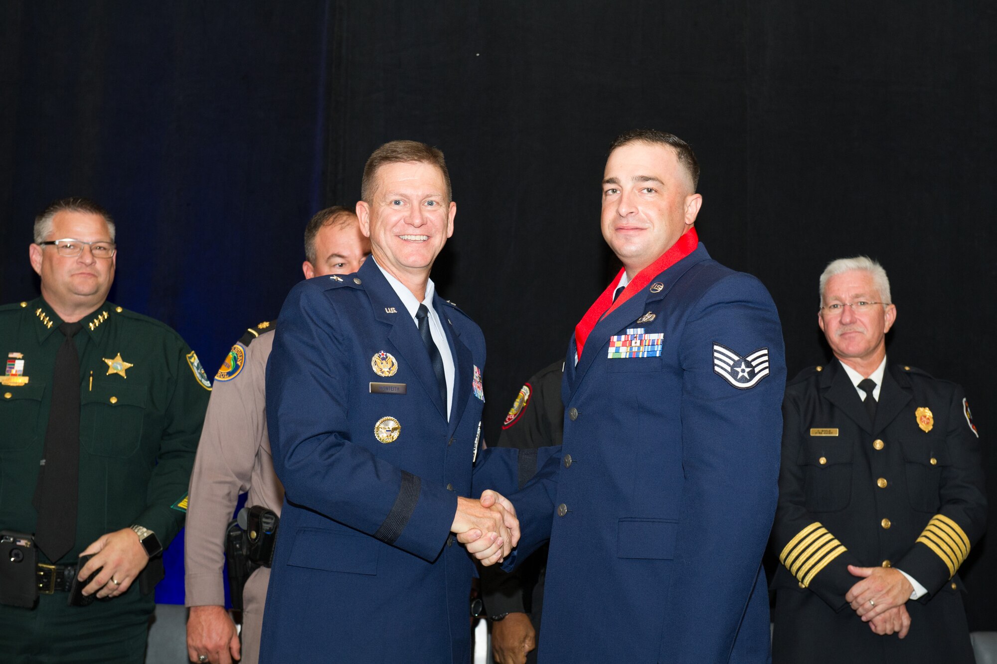 Brig. Gen. Wayne Monteith, 45th Space Wing commander, assists the Melbourne Regional Chamber of East Central Florida with the presentation of the Life Saving Medal to Staff Sgt Michael Hempill, of the 45th Space Wing Civil Engineer Squadron, at the chamber’s Valor Awards banquet on Aug. 17, 2016.  While off duty and fishing at Patrick Air Force Base’s Outdoor Recreation on base area with family and friends Hemphill immediately responded to another family’s cry for help after a man fell out of his kayak. (U.S. Air Force photos/Benjamin Thacker/Released)