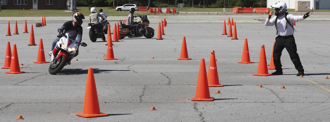 Sgt. Zachary Bray, left, data network specialist with Headquarters and Support Battalion, practices his slow precise control on his 2013 Honda CBR 1000 RR with Mark Brown, right, owner and lead instructor of Motor Mark 1 Motor Skill Enhancement, at Marine Corps Auxiliary Landing Field Bogue, North Carolina, Aug. 14. Bike Safe is a proactive approach to engage motorcyclist before they do something that’s unsafe. (U.S. Marine Corps photo by Lance Cpl. Tavairus Hernandez /Released)