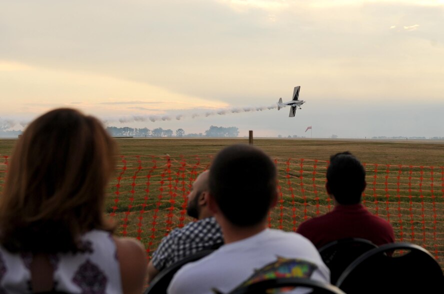 Spectators watch various aircraft practice during the Northern Neighbors Day practice show at Minot Air Force Base, N.D., Aug. 12, 2016. The air show hosted a variety of demonstrations, both aerial and static. (U.S. Air Force photo by Staff Sgt. Chad Trujillo)