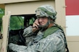 CAMP ATTERBURY, Ind. – Indiana National Guard medic Spc. Matthew Bailey of Sturgis, Mich. stays on emergency watch as his unit fires live mortar rounds during their annual readiness exercise. (Photo by SGT Raymond Maldonado, 206th Broadcast Operations Detachment)