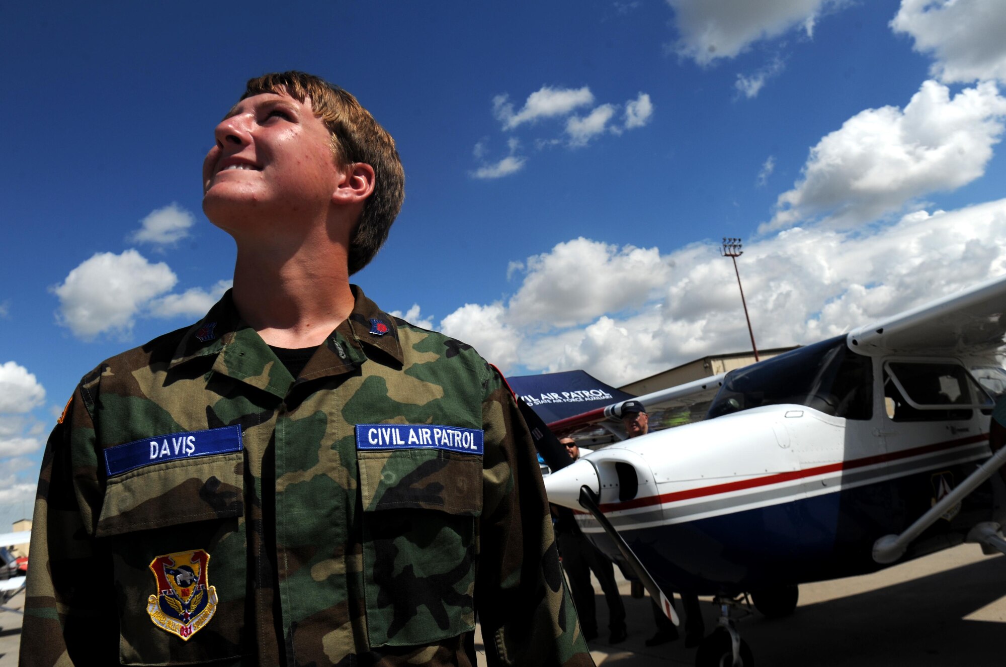 Brady Davis, North Dakota Civil Air Patrol cadet, watches a performer at the Northern Neighbors Day Air Show at Minot Air Force Base, N.D., Aug. 13, 2016. The air show was the first Minot AFB has hosted in seven years and featured several civilian and military aircraft. (U.S. Air Force photo by Staff Sgt. Chad Trujillo)