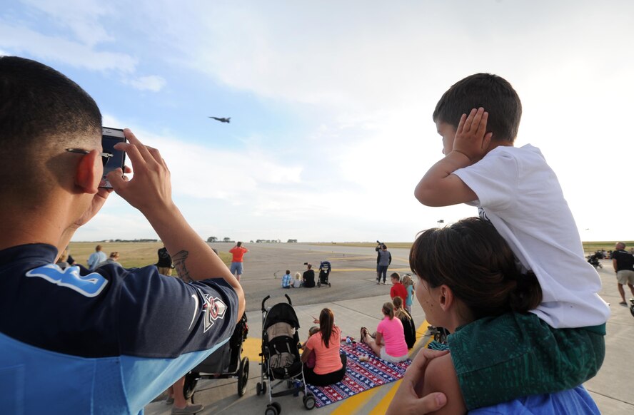 Spectators watch various aircraft practice during the Northern Neighbors Day practice show at Minot Air Force Base, N.D., Aug. 12, 2016. The air show was the first Minot AFB has hosted in seven years. (U.S. Air Force photo by Staff Sgt. Chad Trujillo)