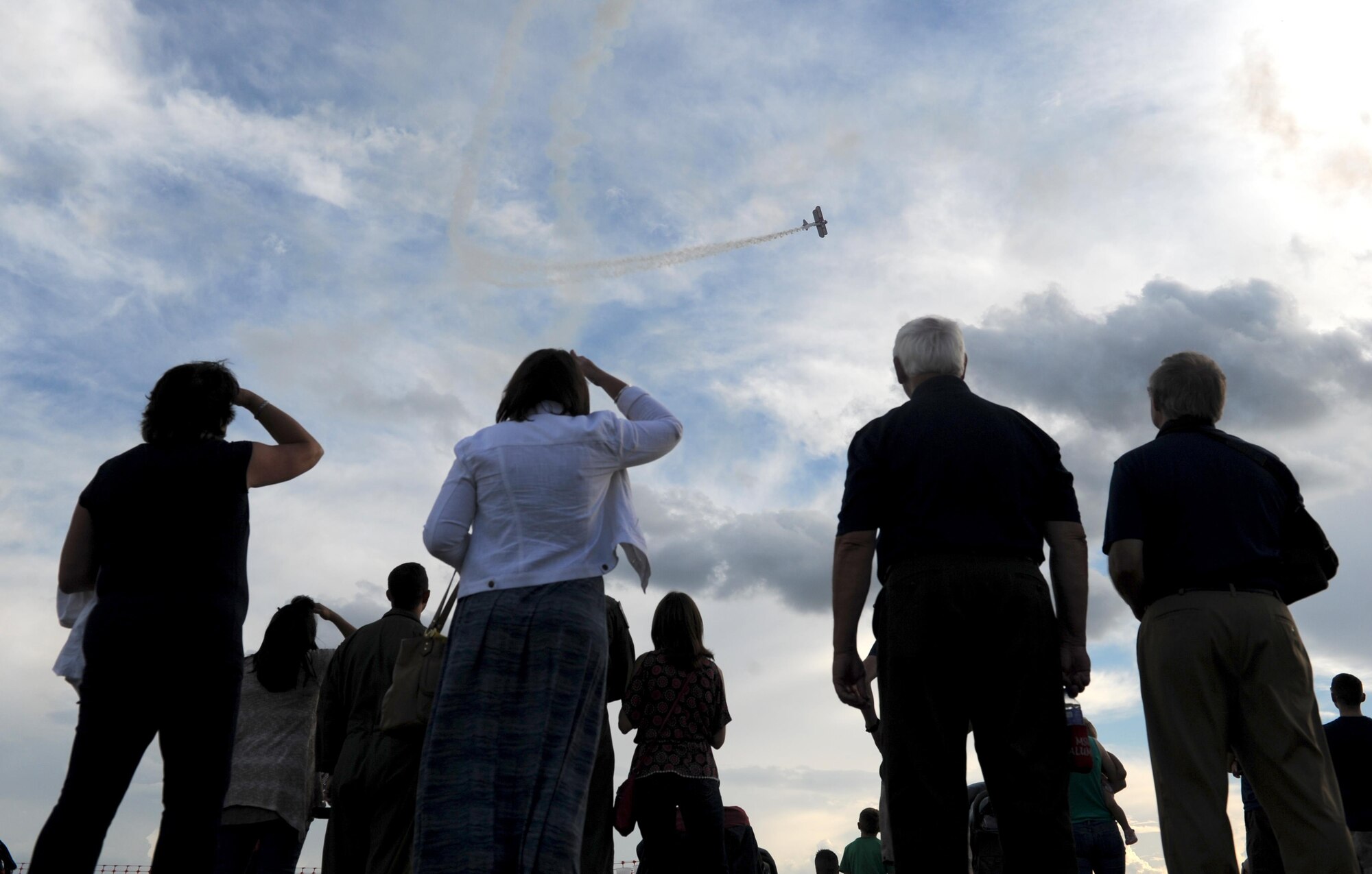 Spectators watch an acrobatic display during the Northern Neighbors Day practice show at Minot Air Force Base, N.D., Aug. 12, 2016. The air show was the first Minot AFB has hosted in seven years. (U.S. Air Force photo by Staff Sgt. Chad Trujillo)
