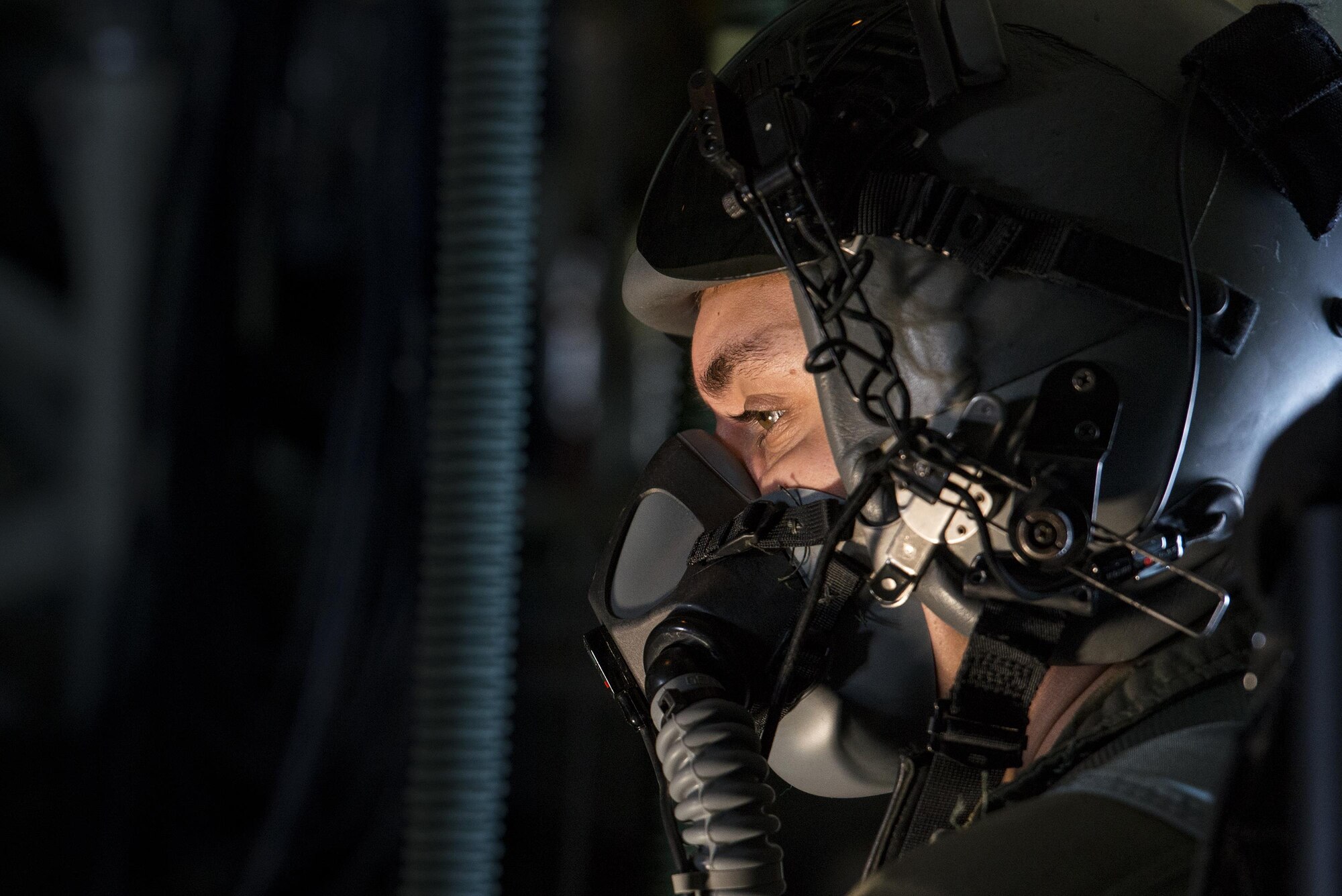 U.S. Air Force Staff Sgt. Christopher Bright, 71st Rescue Squadron loadmaster, breathes oxygen through a regulator and mask in the back of an HC-130J Combat King II, Aug. 18, 2016, in the skies over Moody Air Force Base, Ga. During operations at high altitudes, crew members are required to breathe 100 percent pure oxygen to combat the lowered oxygen levels present. (U.S. Air Force photo by Staff Sgt. Ryan Callaghan)
