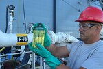 DLA Energy Pacific’s Army Master Sgt. John Vanderstigchel, DLA Joint Reserve Force, performs a visual inspection on a quart sample of F-76 diesel marine fuel for the DLA Energy Pacific laboratory for quality assurance purposes during RIMPAC 2016. Samples must pass the ‘clear and bright’ test during inspection to ensure optimum quality.