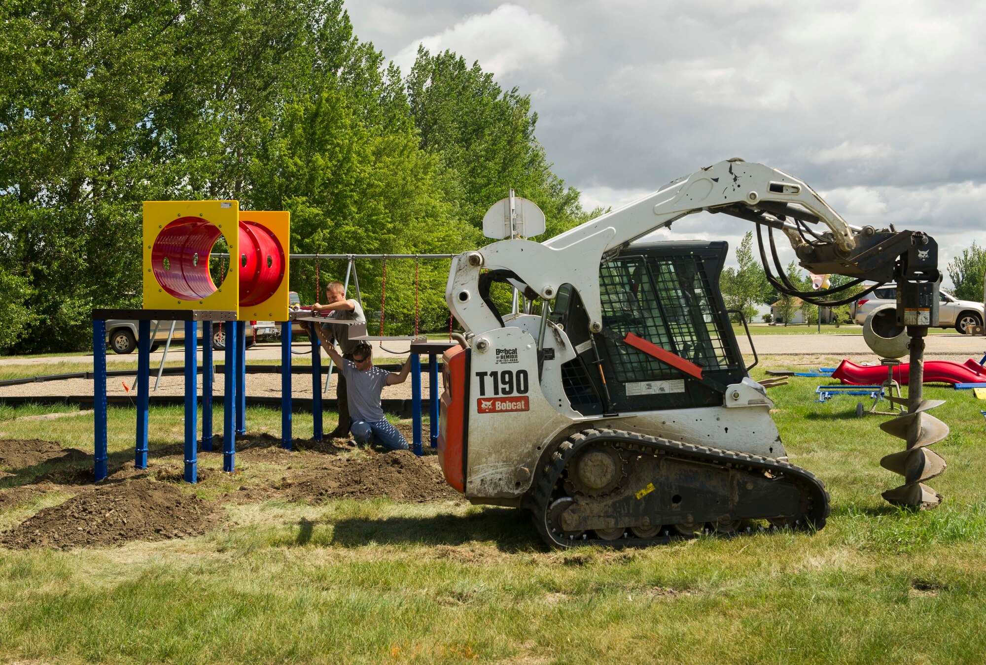 Volunteers build playground equipment at Dakota Elementary on Minot Air Force Base, N.D., Aug. 4, 2016. The equipment will create an outdoor interactive classroom for pre-kindergarten students on base. (U.S. Air Force photo/Senior Airman Apryl Hall)