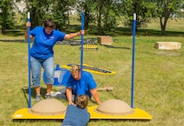 Karen Knowles (left), Minot Head Start program director, and other volunteers put together playground equipment at Dakota Elementary on Minot Air Force Base, N.D., Aug. 4, 2016. The new equipment meets pre-school regulations, and will be available for Head Start students this school year. (U.S. Air Force photo/Senior Airman Apryl Hall)
