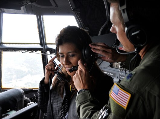 Rebecca Small listens in to in-flight radio chatter with the assistance of Air Force Reserve Lt. Col. "Fritz" during an orientation flight over southern Colorado, Aug. 5, 2016. Small, an employment coordinator with the Colorado Employer Support for the Guard and Reserve, together with more than 40 other employers and supervisors, took part in the wing's annual Employer Appreciation Day at the base. The day aims to both educate and recognize employers and supervisors of Air Force Reservists for their ongoing support to the member's military commitment. Vanselow is a regional operations manager for Solar Transport, while Peterson is a quality assistance supervisor with the Defense Contracts Management Agency. Fritz is a C-130 Hercules navigator assigned to the 731st Airlift Squadron. (U.S. Air Force photo/2nd Lt. Stephen J. Collier)